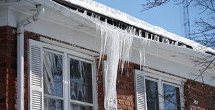 Roof with icicles hanging from it.